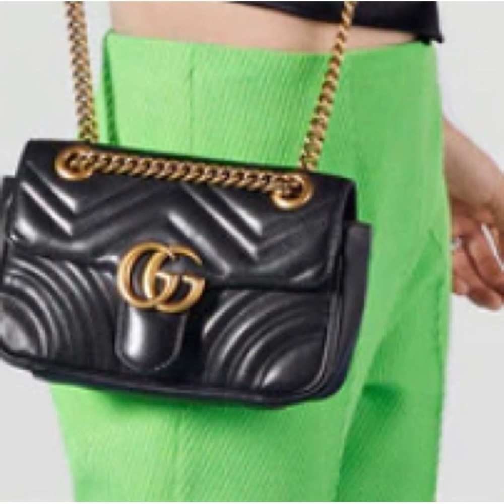 Gucci black leather purse with lions gate lock front.